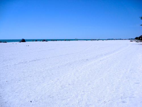 a white beach with the ocean in the background at Absolute Anna Maria-Private Beach Access-Heated Pool-Water Views From Every Room in Bradenton Beach