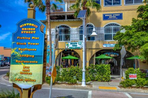 a sign on a street in front of a building at Absolute Anna Maria-Private Beach Access-Heated Pool-Water Views From Every Room in Bradenton Beach