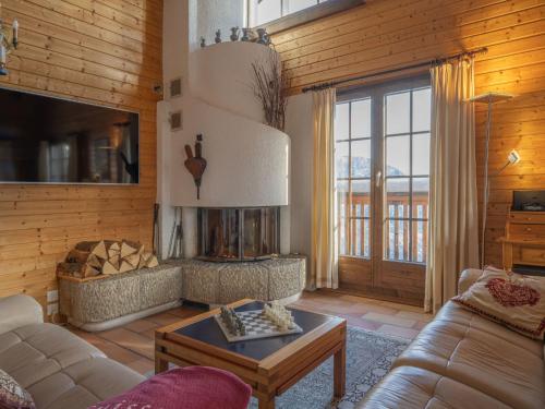 a living room with a couch and a table at Chalet Le Sorbier by Interhome in Chamoson