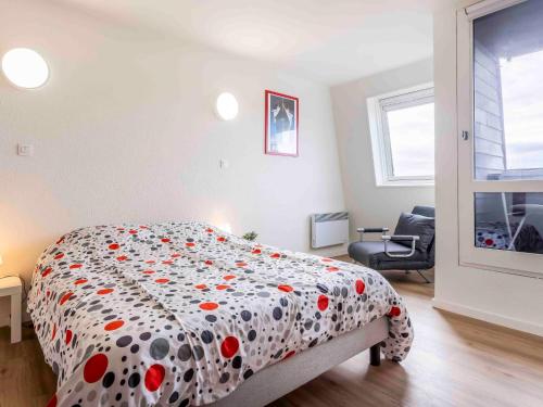 sypialnia z łóżkiem z narzutą polka w obiekcie Studio Les Marinas-14 by Interhome w mieście Deauville