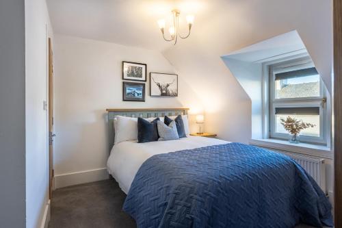 a bedroom with a large bed and a window at Hill Street Haven in Inverness