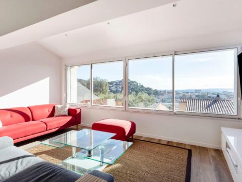 un salon avec un canapé rouge et une table en verre dans l'établissement Holiday Home Gazanias by Interhome, à Bormes-les-Mimosas