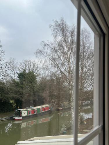a view from a window of a river with boats at Canalside B and B in Yelvertoft