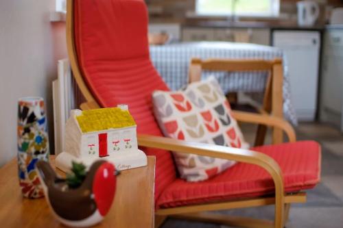 a living room with a chair and a christmas toy at Mary Jane's Cottage, Lettermacaward in Doochary