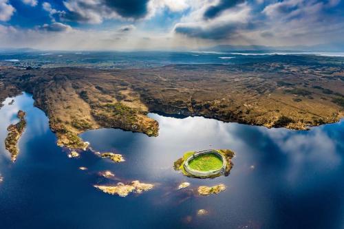 an island in the middle of a body of water at Mary Jane's Cottage, Lettermacaward in Doochary