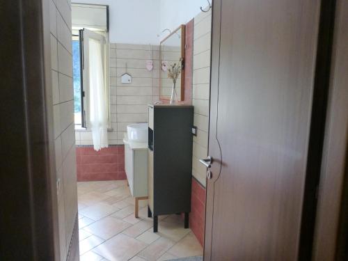 a small bathroom with a sink and a toilet at Casa Margherita in Nebida