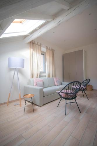 a living room with a couch and a table at Comonfive Apartments in Como