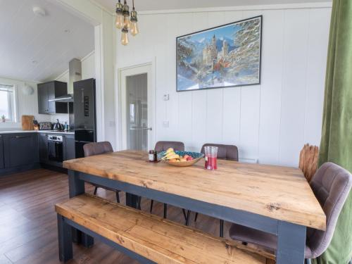 a dining room table with a bowl of fruit on it at Chalet Loch Leven Lodge 25 East by Interhome in Kinross
