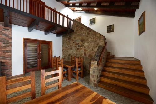 a room with stairs and a dining room with a table at Horská Chata Ještědka in Světlá pod Ještědem
