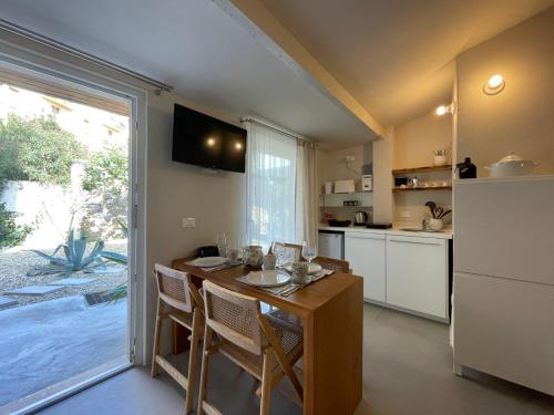 a kitchen with a table with chairs and a refrigerator at Apartment La casa di Manu by Interhome in Porto Maurizio