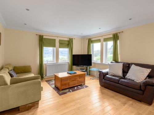 a living room with two couches and a tv at Holiday Home The Firs by Interhome in Drumnadrochit