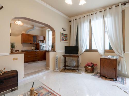 een grote woonkamer met een televisie en een keuken bij Holiday Home Margherita by Interhome in Dolceacqua