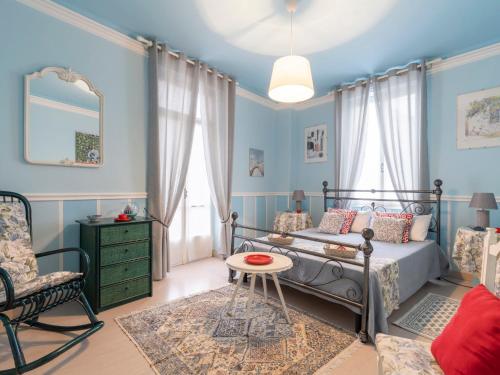 een slaapkamer met een bed, een stoel en een tafel bij Holiday Home Margherita by Interhome in Dolceacqua