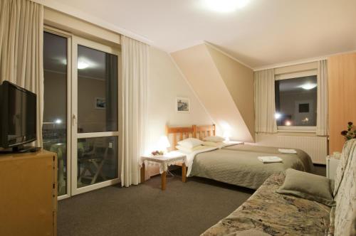 Een bed of bedden in een kamer bij Pensjonat Landrynka