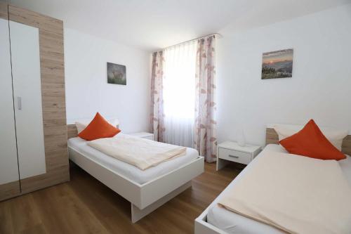1 dormitorio con 2 camas y ventana en KAISERS das kleine Stadthotel en Sonthofen