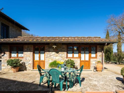 a table and chairs in front of a stone house at Holiday Home Casa Mario by Interhome in Greve in Chianti