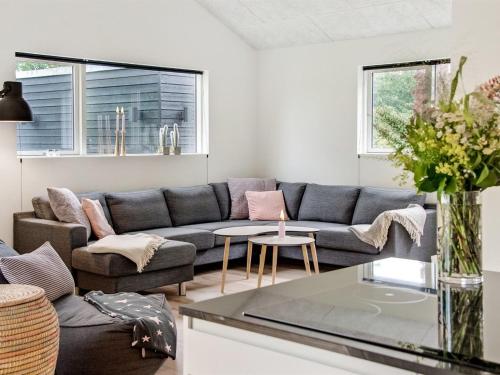 a living room with a couch and a table at Holiday Home Dorthie - 800m from the sea by Interhome in Hornbæk