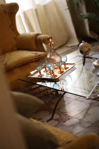 a living room with a table with glasses on it at Historical Suites VVM in Lecce
