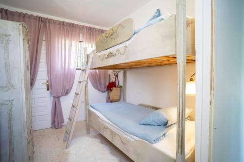 a bedroom with two bunk beds and a ladder at Casa Ancladero Big rooftop terrace, 2 bedroom guesthouse w garden and view in Fuengirola