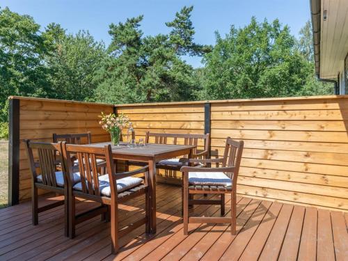 a wooden deck with a table and chairs at Holiday Home Selma - 300m from the sea in Bornholm in Vester Sømarken