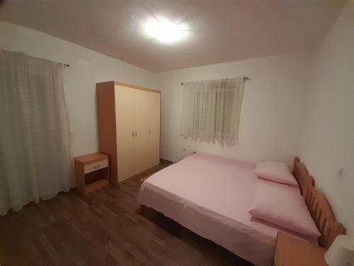 a small bedroom with a bed and a door at Marko in Podstrana