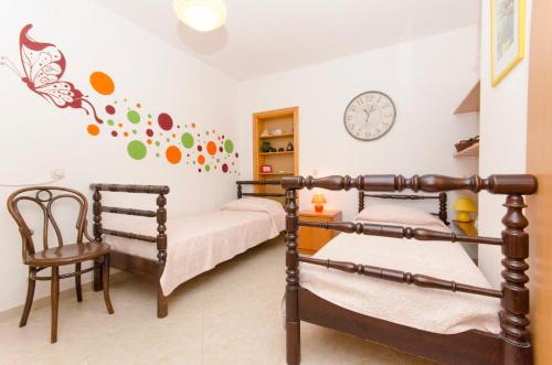 a bedroom with two bunk beds and a clock on the wall at House Petric in Bol