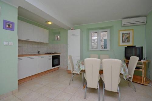a kitchen with a table and chairs in a kitchen at House Marija in Lastovo