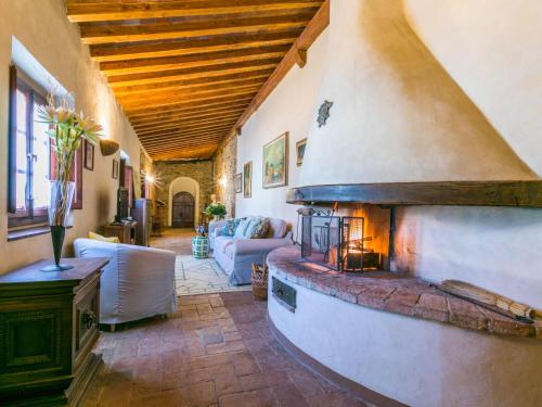 a living room with a fireplace in a house at Apartment Il Convento by Interhome in Bargino