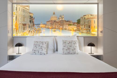a bedroom with a large window with a view of a city at Baía I by An Island Apart in Funchal