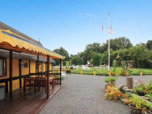 a pavilion with tables and chairs in a park at Apartment Annamia - 250m from the sea by Interhome in Neksø