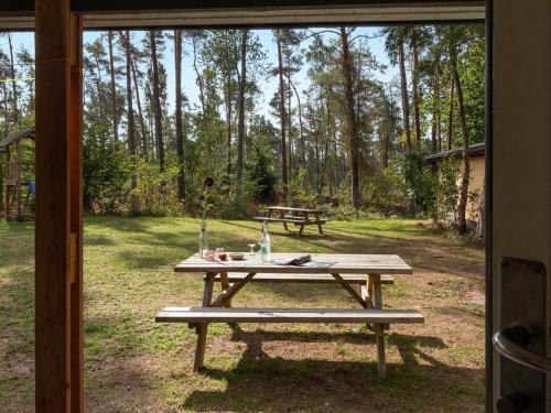 a picnic table with a bench in a yard at Holiday Home Henri - 800m from the sea in Bornholm by Interhome in Neksø
