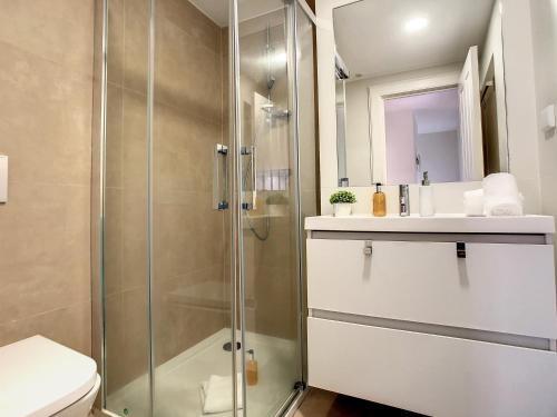 a bathroom with a shower and a toilet and a sink at FX City Lover by LovelyStay in Funchal