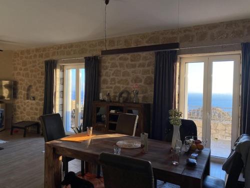 a dining room with a table with chairs and a view at Rapunzel's Tower Mani in Neokhórion