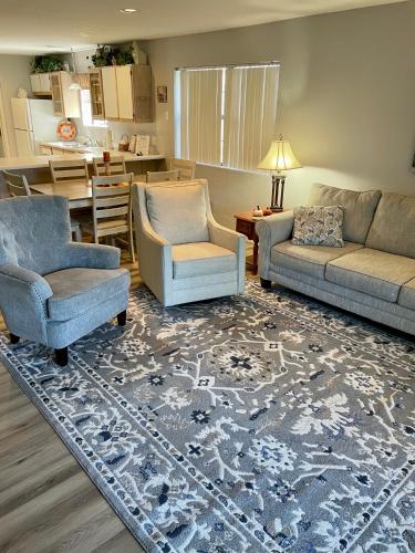 a living room with two chairs a couch and a table at Escape To Branson in Branson