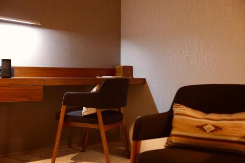 a room with a desk and a chair and a table at Andaru Collection Niseko in Kutchan