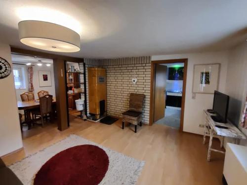 a living room with a red rug and a living room at Gemütliche Bauernkate für 4 mit Kachelofen in Lelkendorf