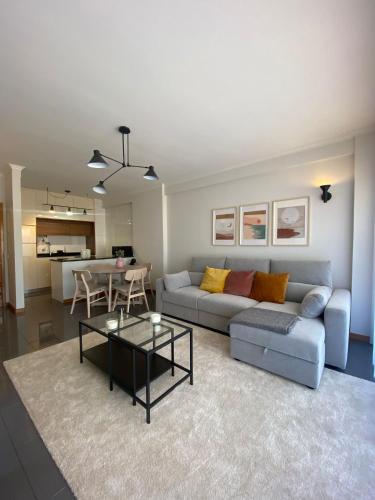 a living room with a couch and a table at Apartamento Central in Braga