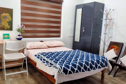 a bedroom with a bed and a flag on the wall at Ivy Cottage in Mananthavady