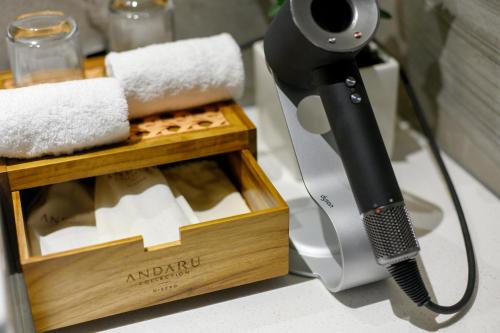 a hair dryer sitting next to a box of towels at Andaru Collection Niseko in Kutchan