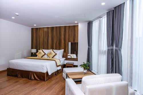 a hotel room with a bed and a couch at The King Hotel - Condotel Thai Nguyen in Thái Nguyên
