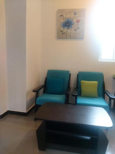 a waiting room with two chairs and a table at Anusha Apartment 15 Homestay in Galle
