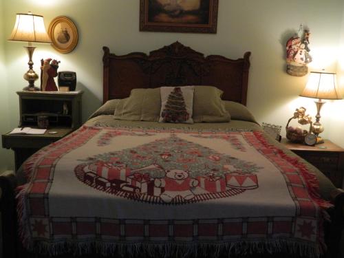 a bedroom with a christmas quilt on a bed at EJ Bowman House Bed & Breakfast in Lancaster