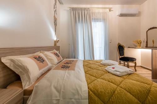 a bedroom with a large bed and a table at Psyche & Eros Mythical Suites in Athens