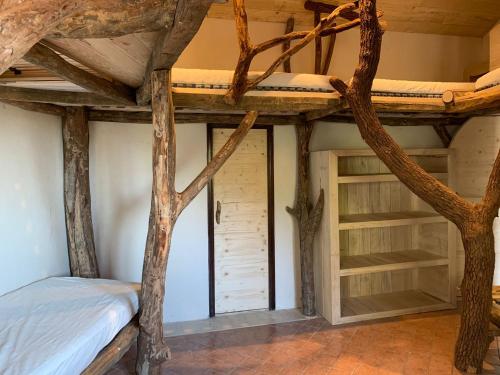 a room with a bunk bed and some trees at Grand Gîte Les Cabanes de Fallot pour 19 personnes - piscine naturelle in LʼIsle-Bouzon