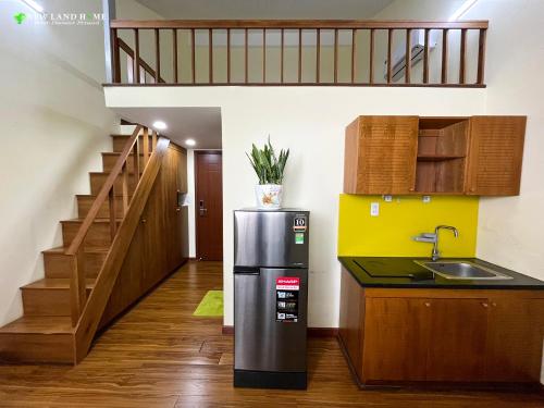 a kitchen with a sink and a refrigerator at NEW LAND Apartment - Nam Thong 3, Phu My Hung in Ho Chi Minh City