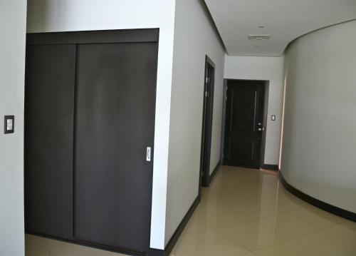 a hallway with two sliding doors in a building at Puerto Azul Hotel in Puntarenas