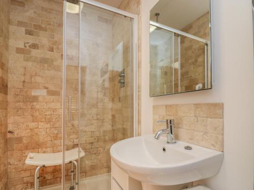 a bathroom with a sink and a shower at Siena in Kilgetty