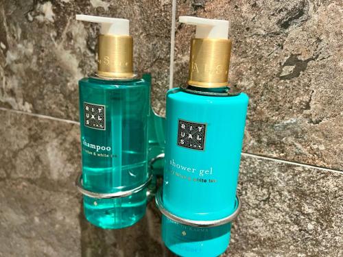two green bottles are sitting next to each other at Hotel de Schelde in Cadzand-Bad