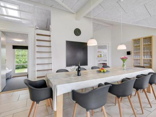 a dining room with a large table and chairs at Holiday Home Finja - 500m from the sea by Interhome in Neder Lysabild