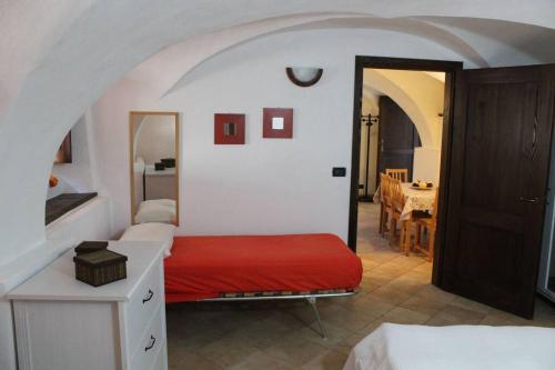 a bedroom with a bed with a red blanket at Casa Griot in Pragelato